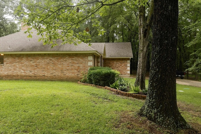 414 Winding Ln, Mount Vernon, TX 75457 - view of home's exterior with brick siding, a lawn, roof with shingles, and a chimney