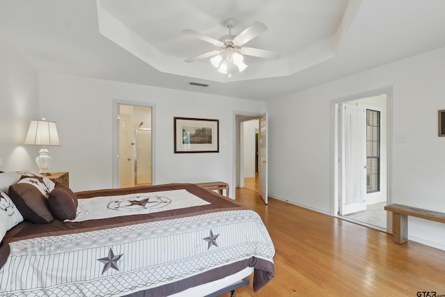 414 Winding Ln, Mount Vernon, TX 75457 - bedroom featuring a raised ceiling, light wood finished floors, and a ceiling fan