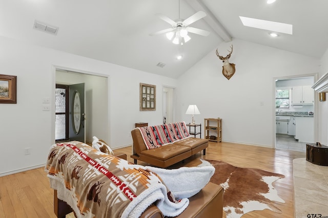 414 Winding Ln, Mount Vernon, TX 75457 - living room with beamed ceiling, light wood-style flooring, ceiling fan, a skylight, and high vaulted ceiling