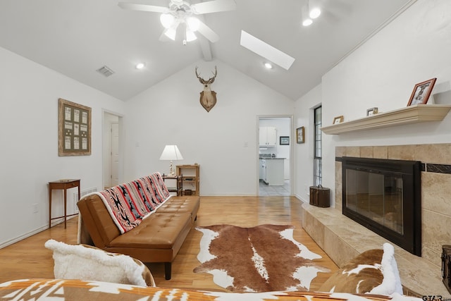 414 Winding Ln, Mount Vernon, TX 75457 - living room featuring ceiling fan, wood finished floors, a skylight, a fireplace, and high vaulted ceiling