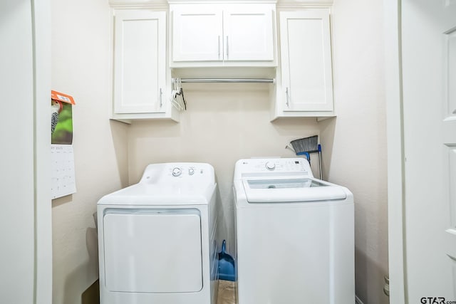 laundry area featuring washing machine and dryer and cabinet space