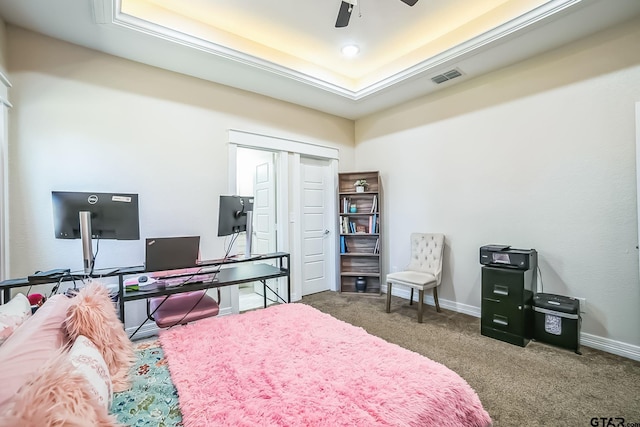 carpeted bedroom featuring a closet, a raised ceiling, visible vents, ceiling fan, and baseboards