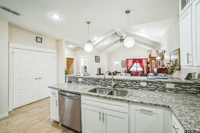 kitchen featuring visible vents, dishwasher, vaulted ceiling with beams, white cabinetry, and a sink