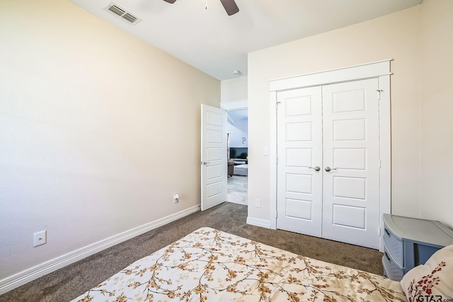 bedroom featuring dark colored carpet, a closet, visible vents, ceiling fan, and baseboards