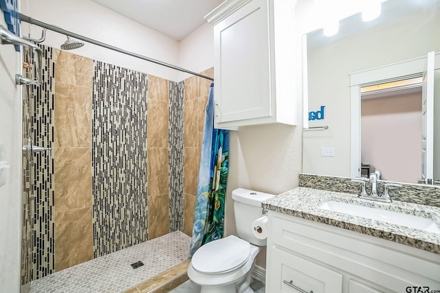 full bath featuring a stall shower, vanity, and toilet