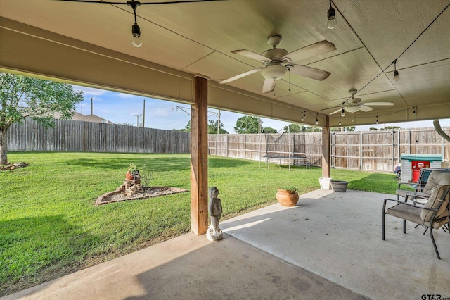 10820 Cactus Trl, Flint, TX 75762 - fenced backyard with a trampoline, a patio, and ceiling fan