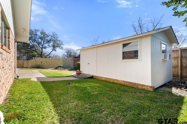 exterior space with an outbuilding, a yard, and cooling unit