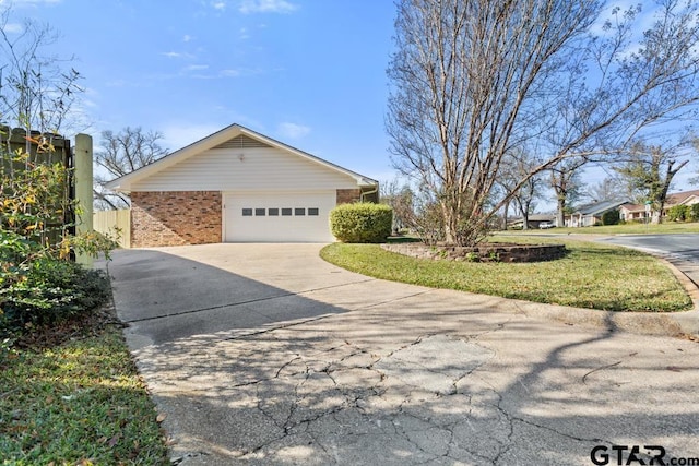 view of side of home with a yard and a garage