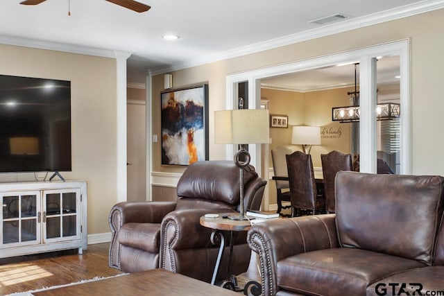 living room featuring dark hardwood / wood-style floors, ceiling fan, and crown molding