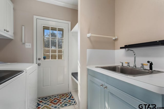 laundry room featuring sink, cabinets, crown molding, light tile patterned flooring, and washer and dryer