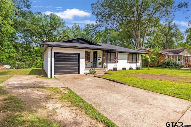 2216 Pleasent Dr, Tyler, TX 75701 - single story home featuring concrete driveway, an attached garage, and a porch