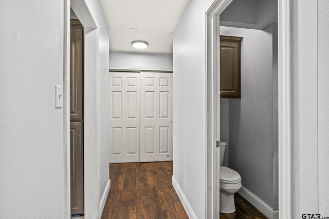 bathroom with wood finished floors, toilet, and baseboards