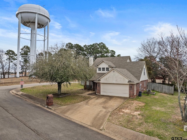 view of front facade with driveway, a garage, fence, a front lawn, and brick siding