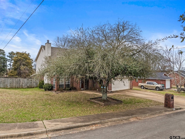 view of property hidden behind natural elements with brick siding, a chimney, concrete driveway, fence, and a front lawn