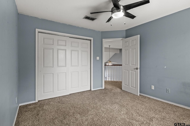 unfurnished bedroom with carpet floors, baseboards, visible vents, and a closet