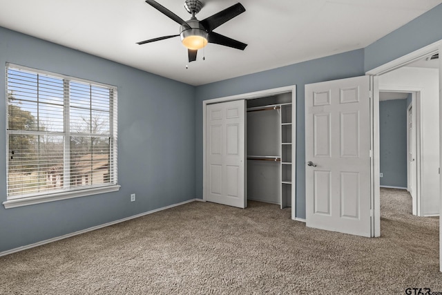 unfurnished bedroom with multiple windows, carpet, a closet, and baseboards