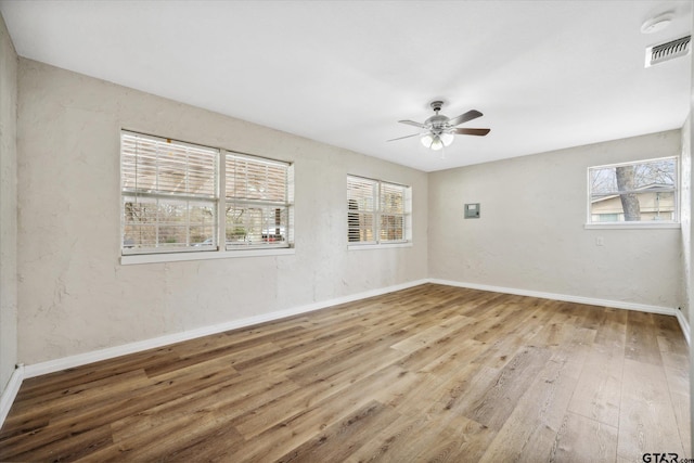 empty room with wood-type flooring and ceiling fan