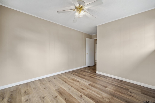 unfurnished room featuring crown molding, light hardwood / wood-style flooring, and ceiling fan