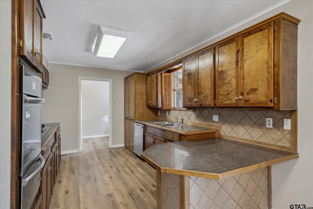 kitchen with sink, decorative backsplash, stainless steel dishwasher, crown molding, and light wood-type flooring