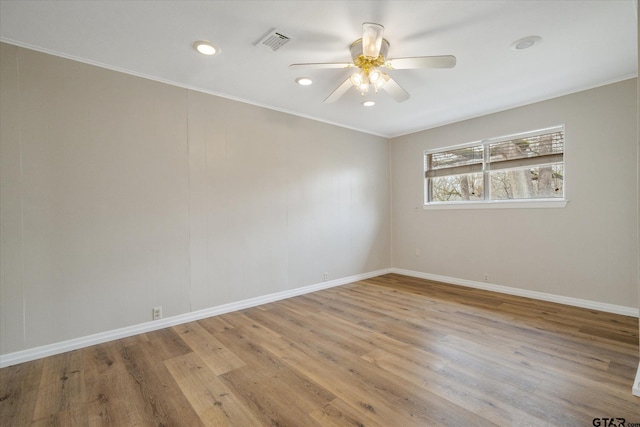 spare room featuring ceiling fan and light hardwood / wood-style floors