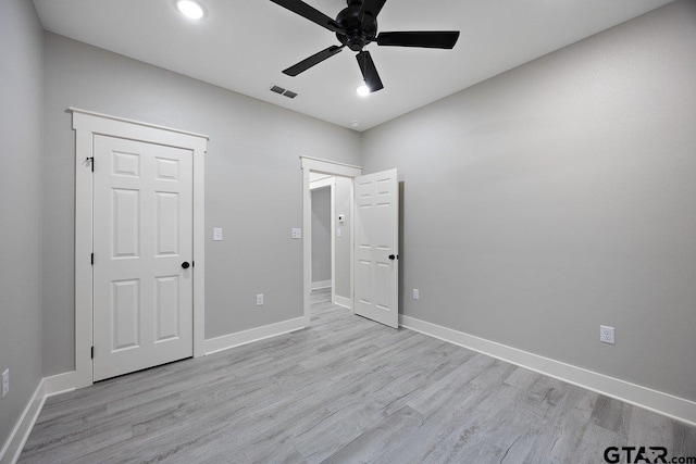 unfurnished bedroom with ceiling fan and light wood-type flooring