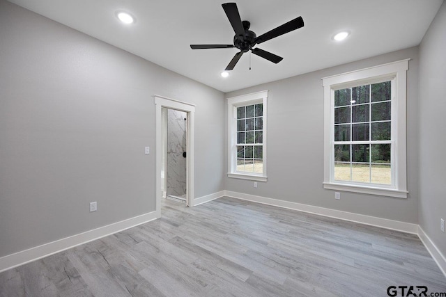 spare room featuring ceiling fan and light wood-type flooring