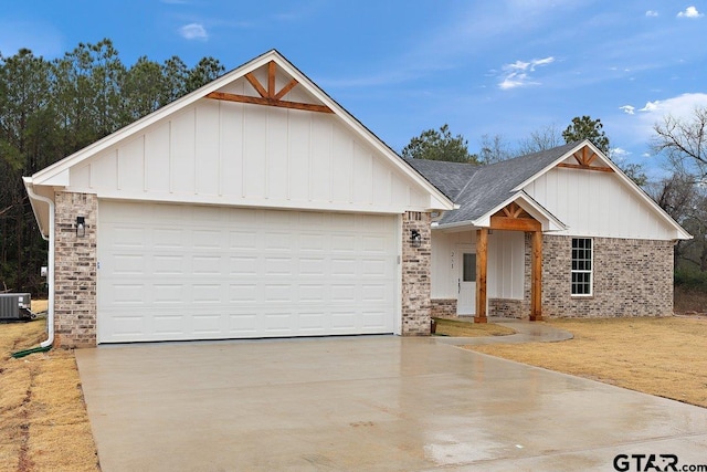 view of front of property featuring a garage and central AC