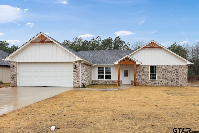 view of front of home with a garage and a front yard