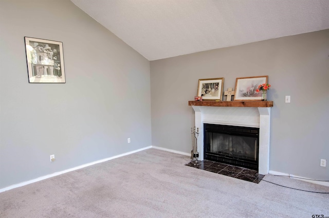 unfurnished living room with carpet and lofted ceiling