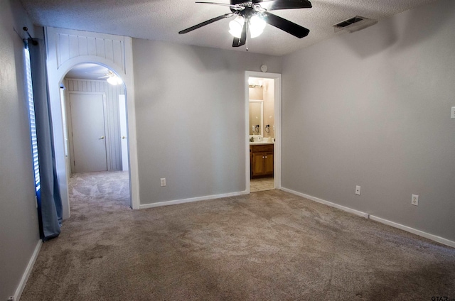 carpeted empty room with a textured ceiling and ceiling fan