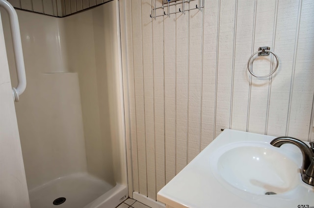 bathroom featuring sink, tile patterned floors, and a shower