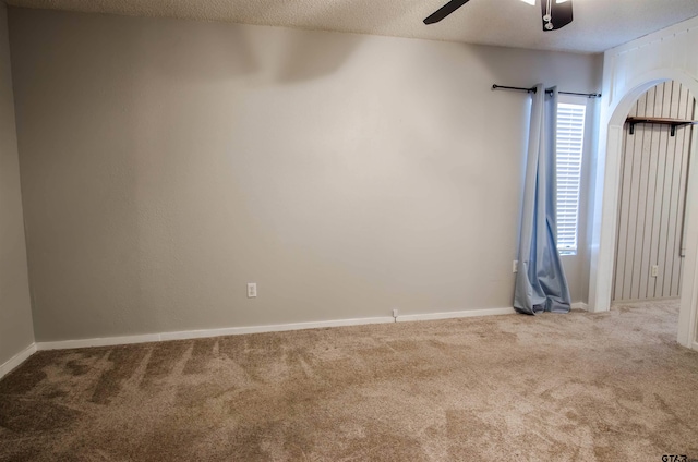 carpeted empty room featuring a textured ceiling and ceiling fan