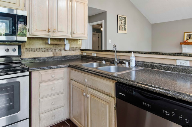 kitchen with stainless steel appliances, sink, light brown cabinets, backsplash, and lofted ceiling