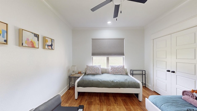 bedroom with ceiling fan, wood finished floors, baseboards, a closet, and recessed lighting
