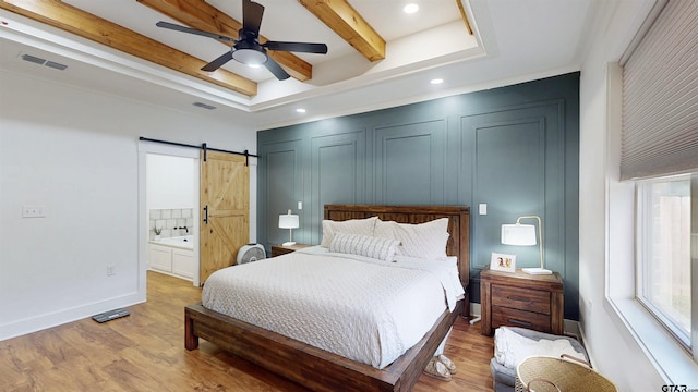 17730 Jayleen Ln, Tyler, TX 75707 - bedroom featuring light wood-style flooring, a barn door, beam ceiling, baseboards, and recessed lighting