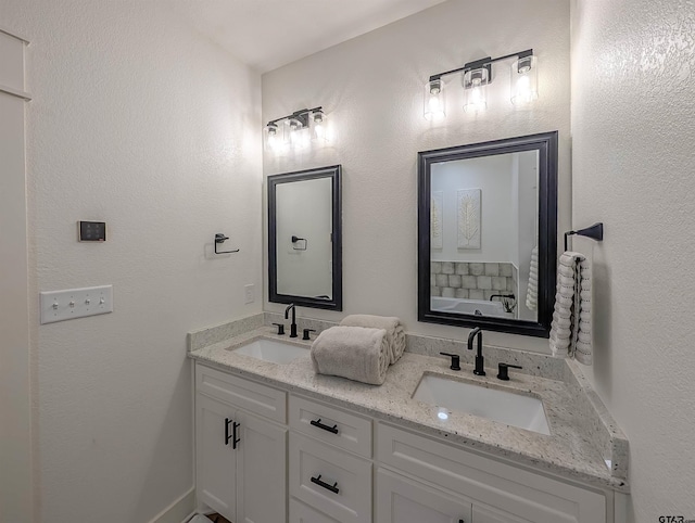 bathroom featuring double vanity and a sink