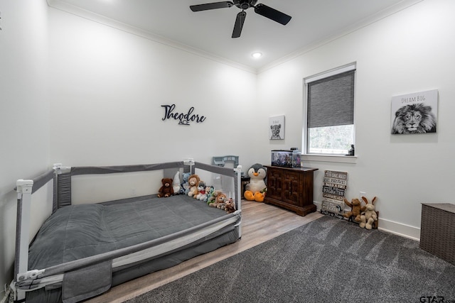 bedroom with hardwood / wood-style floors, ceiling fan, and ornamental molding