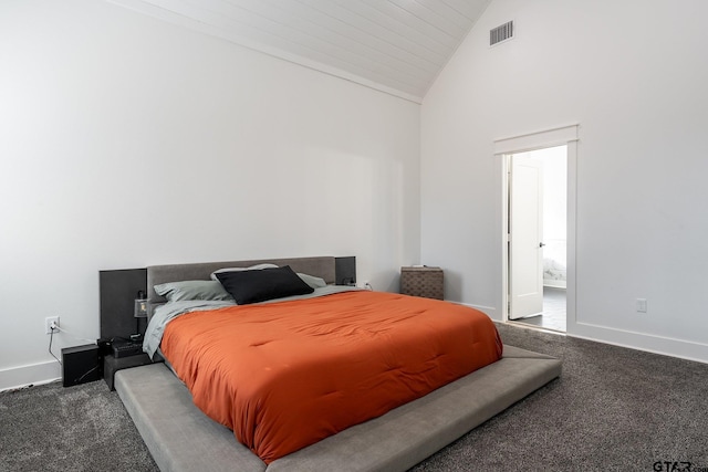 carpeted bedroom with high vaulted ceiling