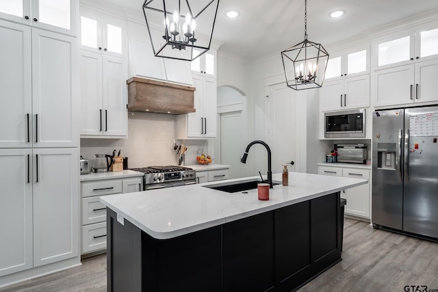 kitchen featuring white cabinetry, a kitchen island with sink, and stainless steel appliances