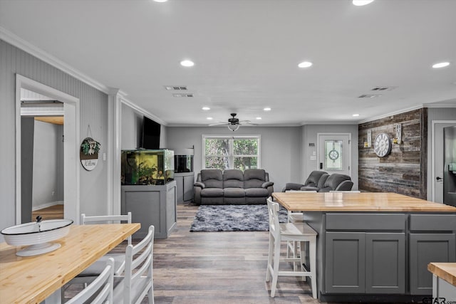 kitchen with gray cabinetry, ornamental molding, wooden counters, hardwood / wood-style flooring, and ceiling fan