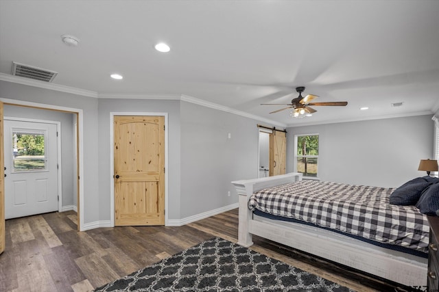 bedroom featuring a barn door, ceiling fan, multiple windows, and dark hardwood / wood-style flooring