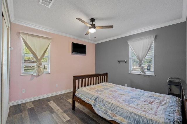 bedroom featuring dark wood-type flooring, ceiling fan, a textured ceiling, and crown molding