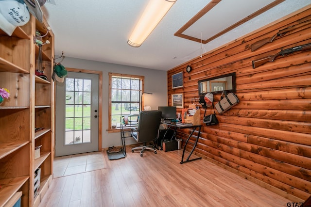 office area with light hardwood / wood-style floors and a textured ceiling