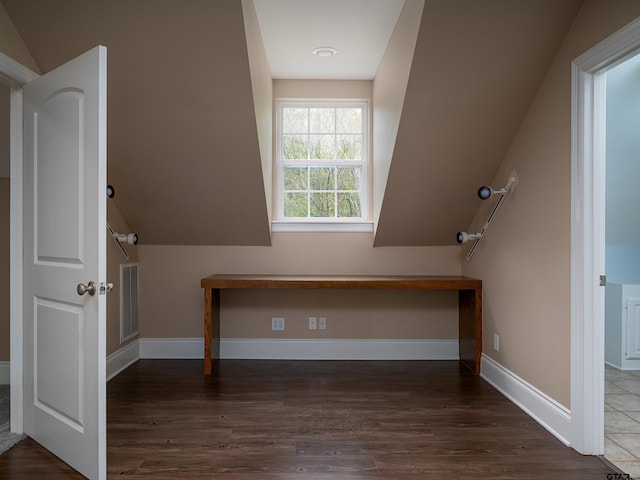 additional living space featuring baseboards, vaulted ceiling, and visible vents