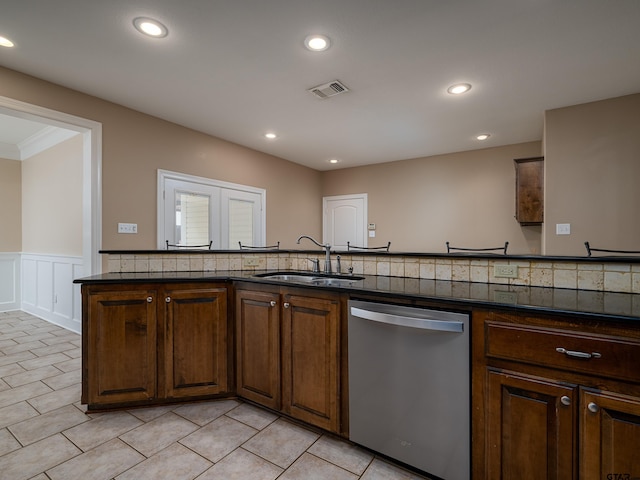 kitchen with a wainscoted wall, a sink, dishwasher, visible vents, and recessed lighting