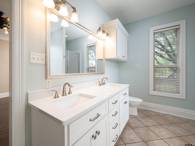 full bathroom featuring double vanity, a sink, a stall shower, and tile patterned floors