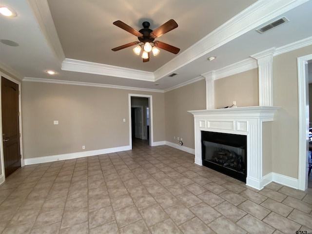 unfurnished living room with ceiling fan, a large fireplace, crown molding, and a raised ceiling