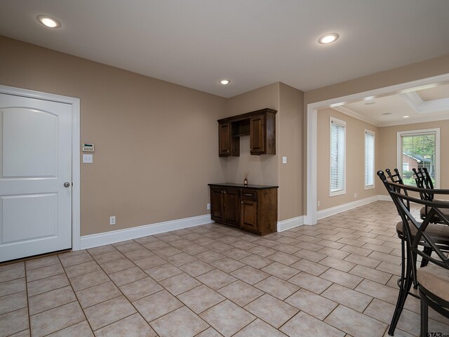 interior space featuring baseboards, dark brown cabinetry, and recessed lighting