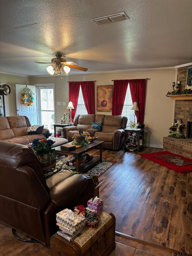 living room featuring dark hardwood / wood-style flooring, a textured ceiling, and a healthy amount of sunlight