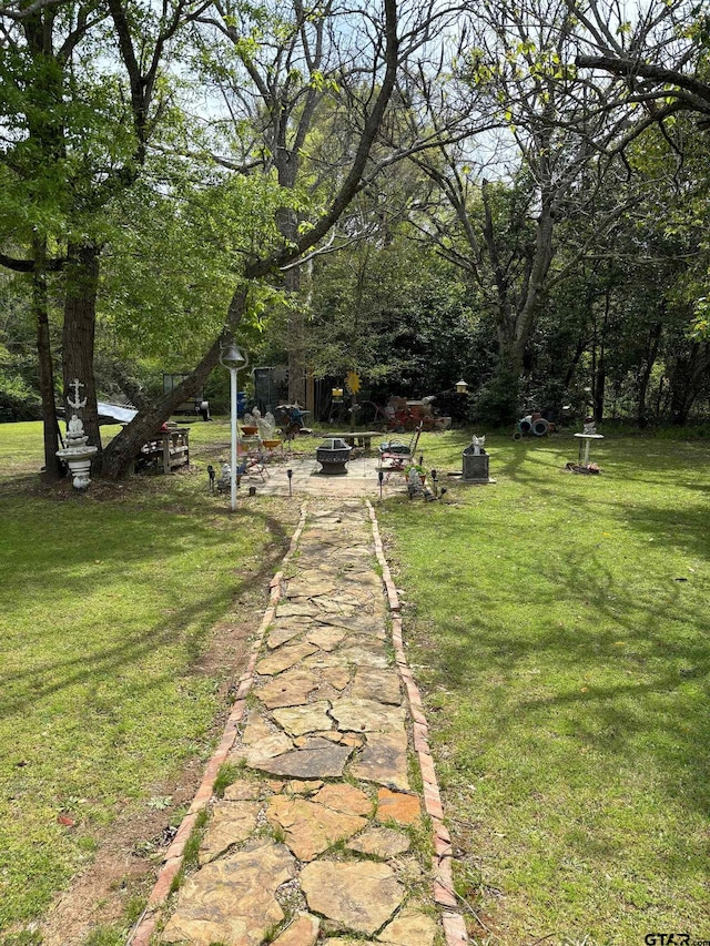 view of yard featuring an outdoor fire pit